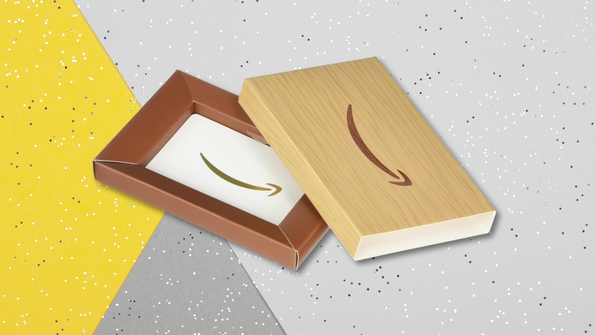 Amazon gift card box with a faux wood lid and a card inside, displayed on a festive background.