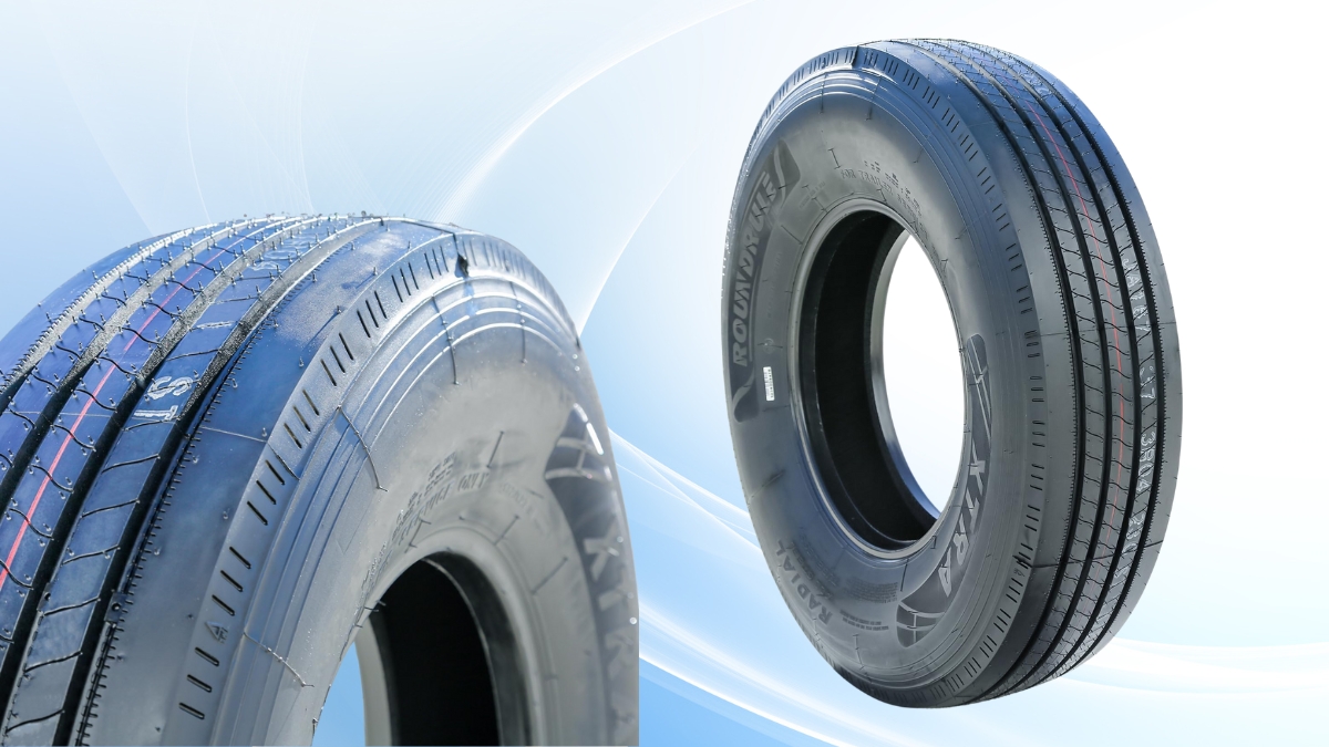 Close-up of a heavy duty trailer tire showing tread pattern and sidewall details on a light background.