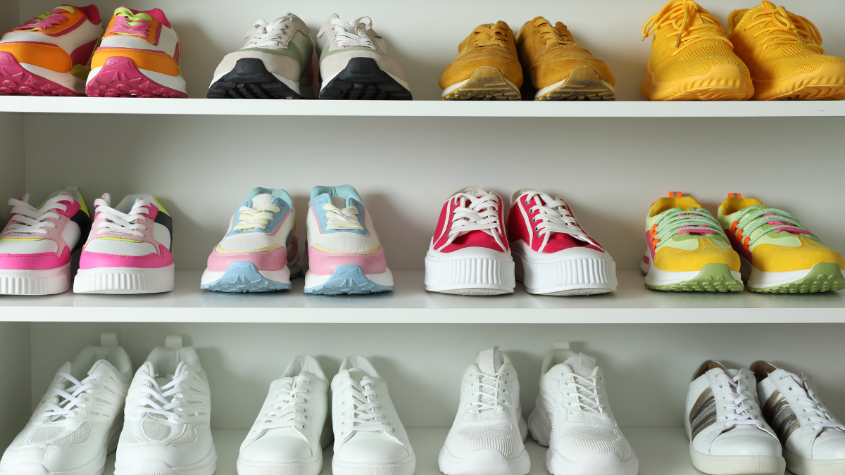 Colorful Kohl’s shoes and sneakers displayed on white shelves in assorted casual and athletic styles.